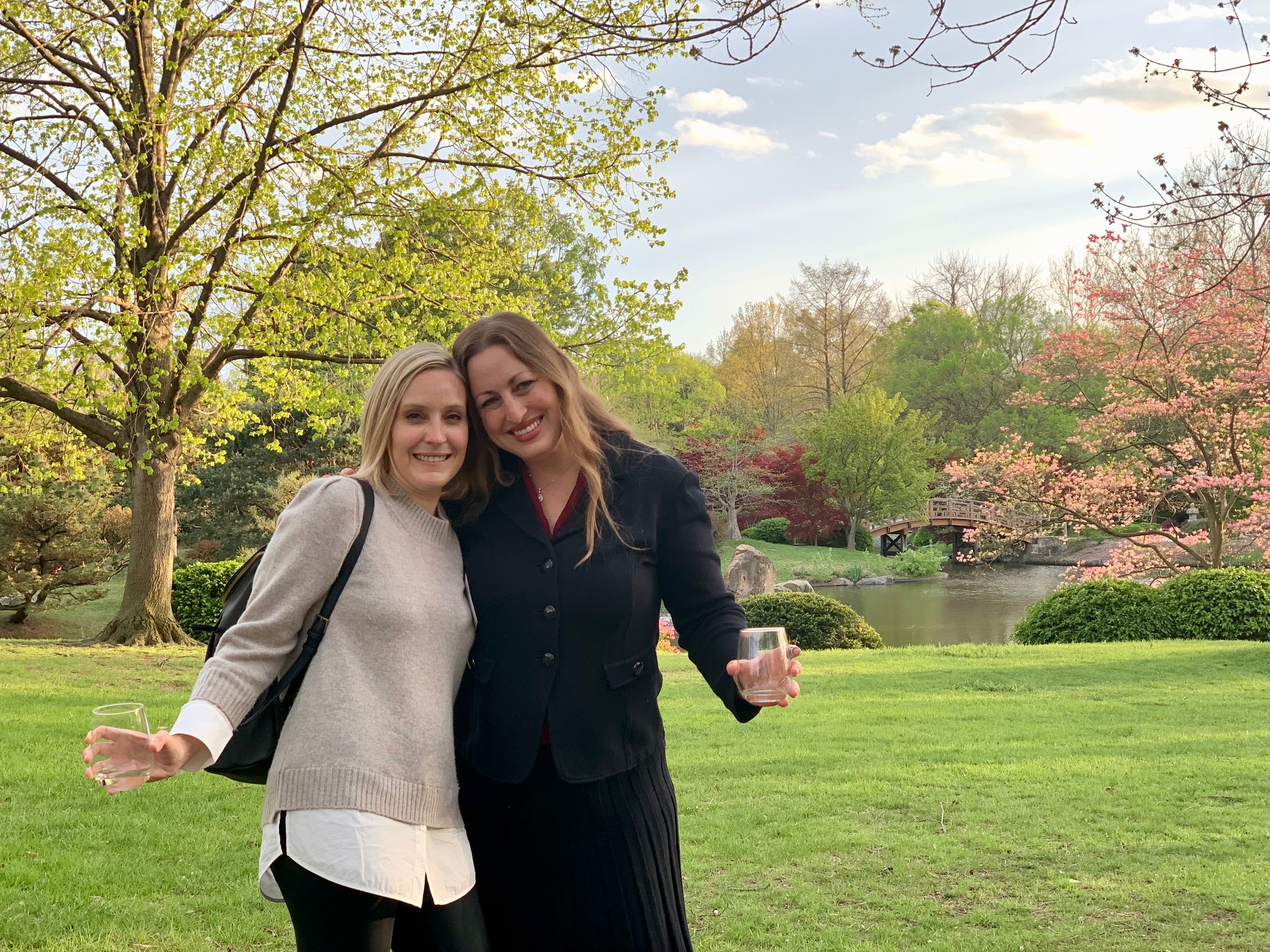 Erin Gibson and Michelle Monje standing together in a park and smiling.