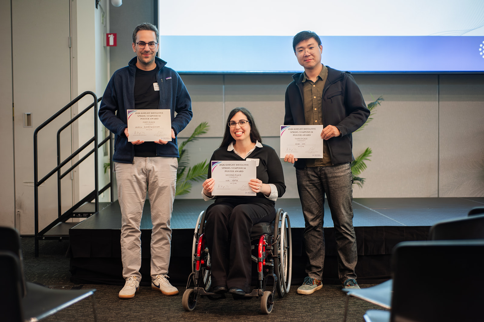 Henrick Riemenschneider, Noa Katz, and Andy Liu hold their best poster awards.