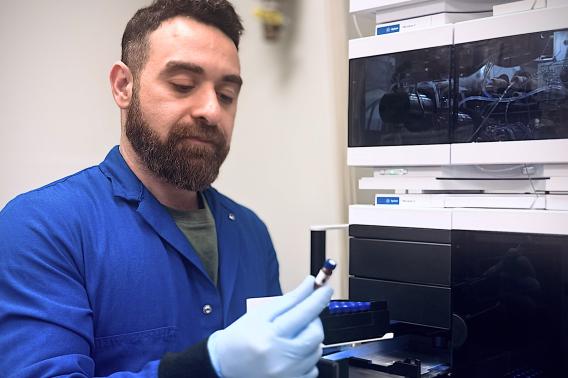 Ali Ghoochani examines samples in the lab. 